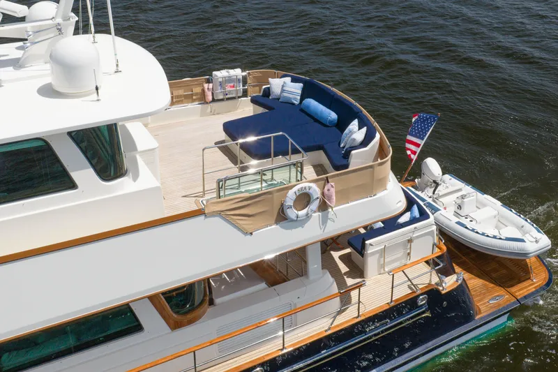Slide: The Image of 2022 Hunt Ocean 76EP yacht with elegant deck and seating, cruising on water. - 7