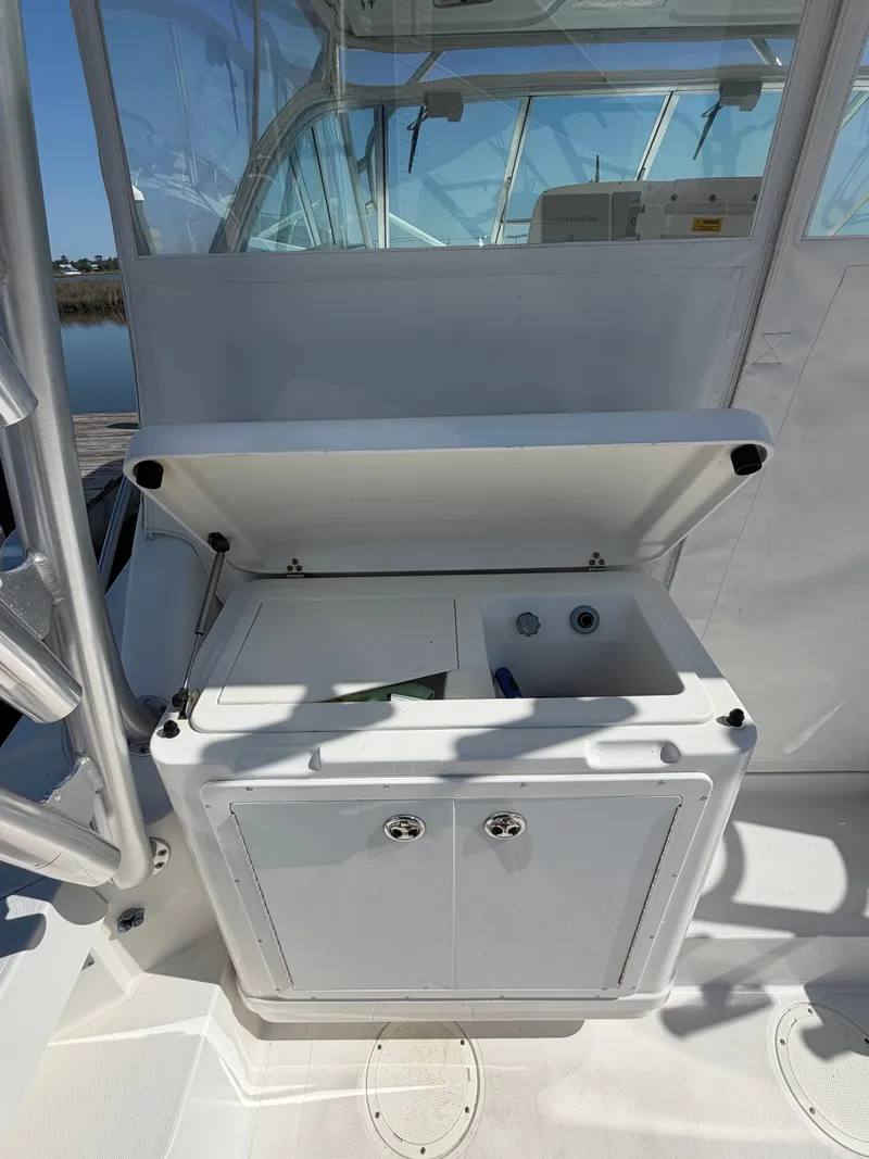 Slide: The Image of 2005 Rampage 33 Express boat kitchenette with sink and storage. - 14
