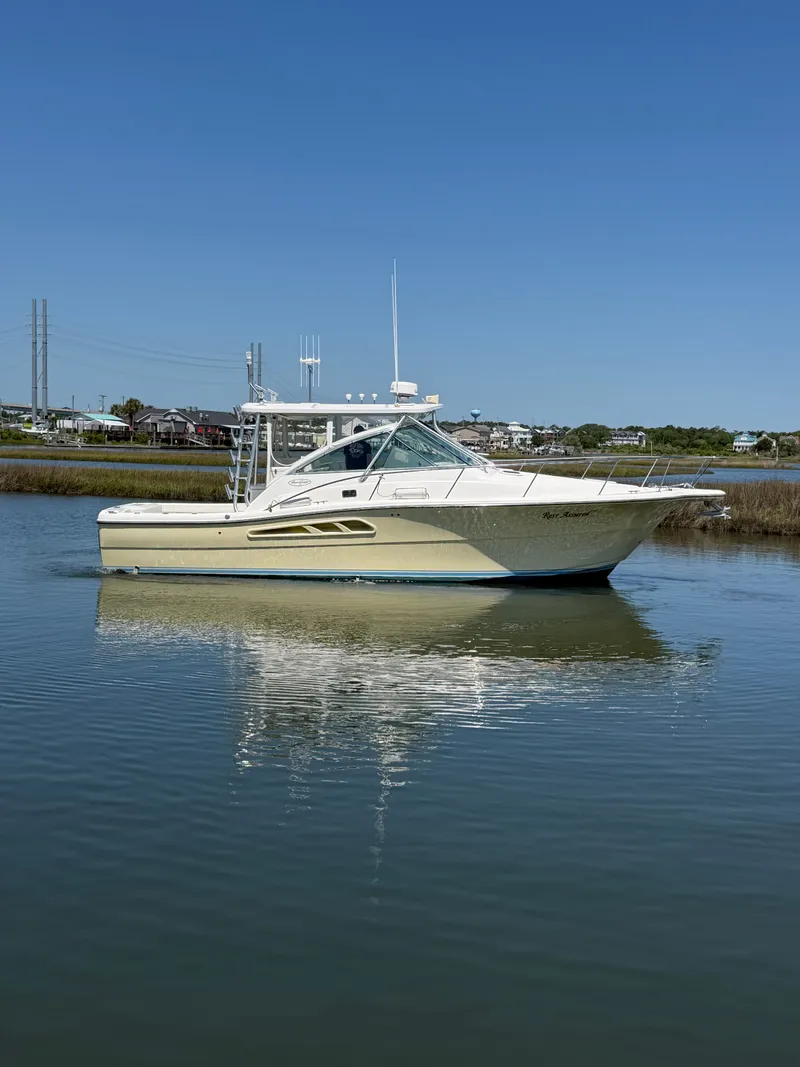 Slide: The Image of 2005 Rampage 33 Express boat on calm water. - 2