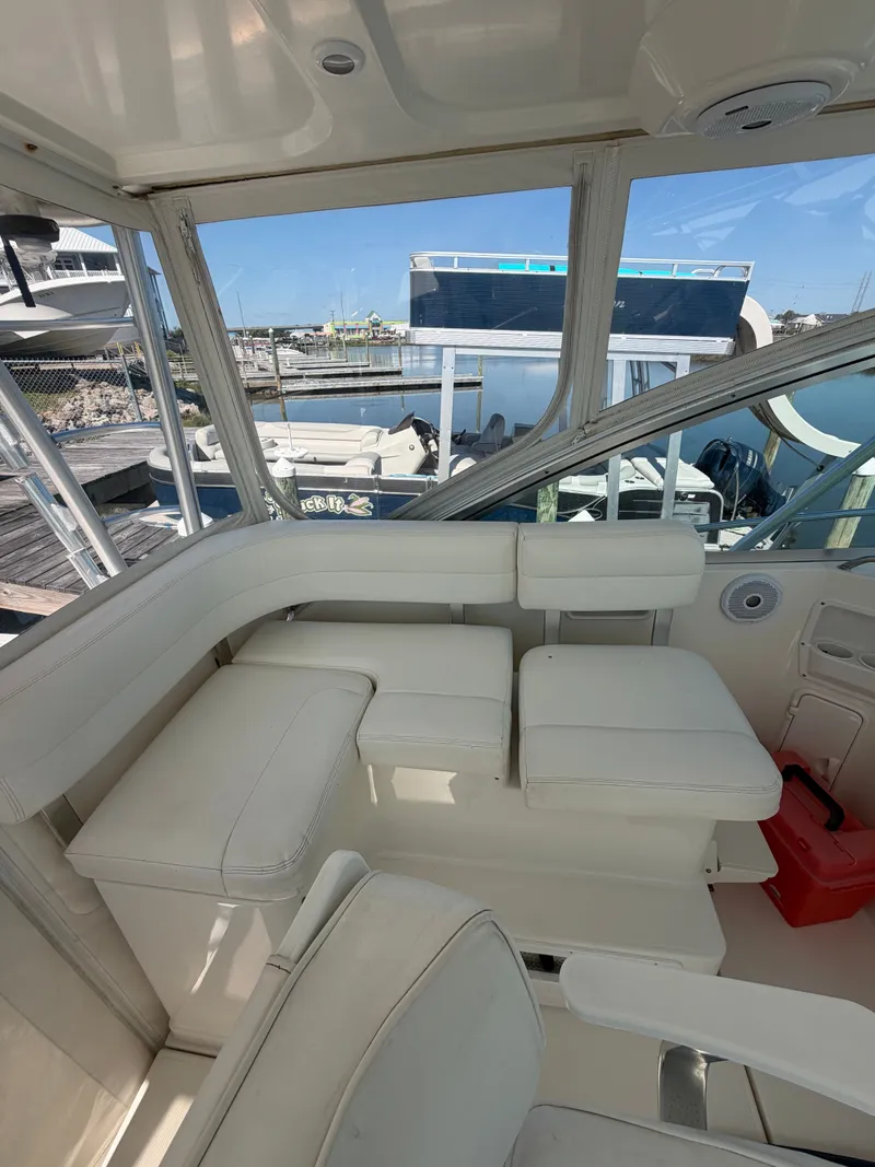 Slide: The Image of Interior of a 2005 Rampage 33 Express yacht with white seating. - 20