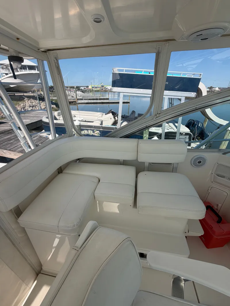 Slide: The Image of Interior of a 2005 Rampage 33 Express yacht with white seating. - 21