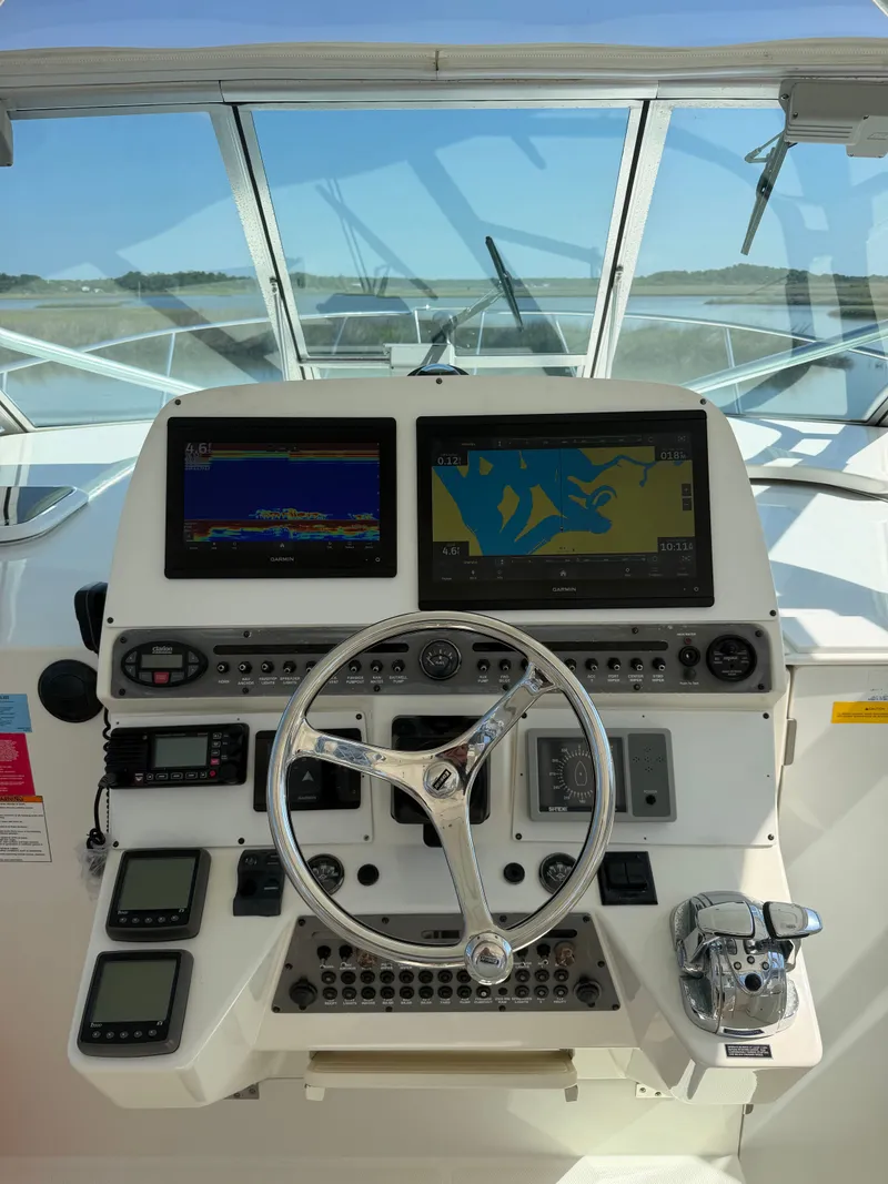 Slide: The Image of 2005 Rampage 33 Express boat helm with navigation systems. - 22