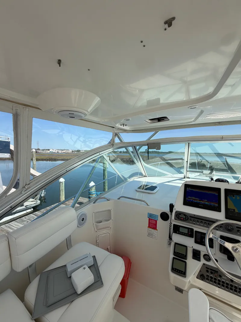 Slide: The Image of Interior view of a 2005 Rampage 33 Express boat with helm console. - 24