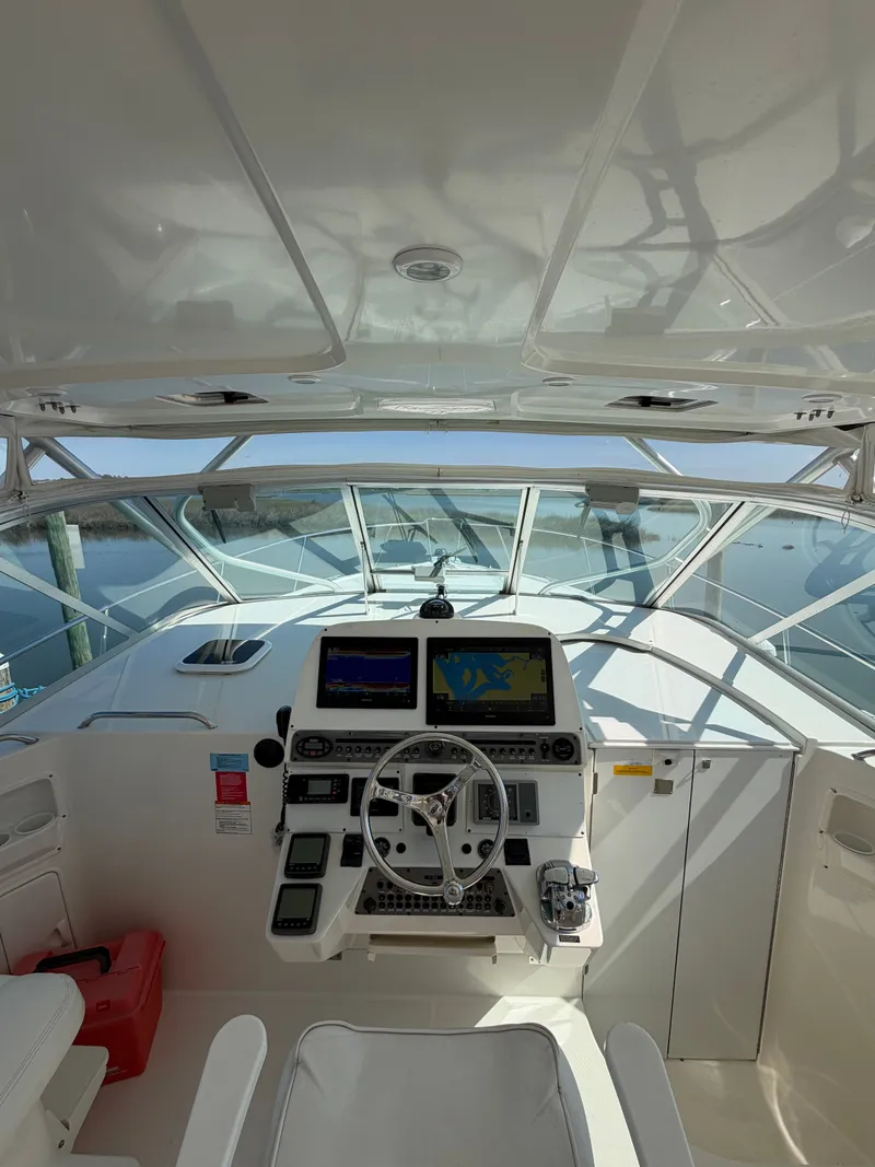 Slide: The Image of Interior view of a 2005 Rampage 33 Express yacht helm. - 27
