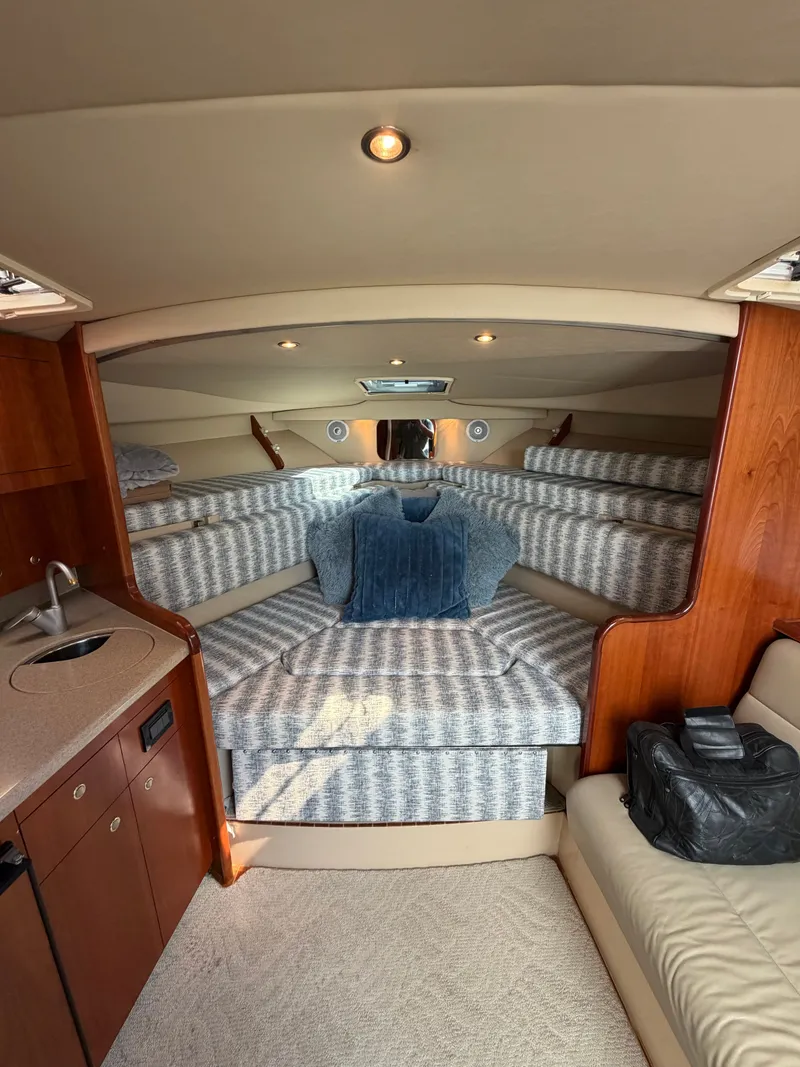 Slide: The Image of Interior of 2005 Rampage 33 Express with cozy bed and wooden cabinetry. - 43