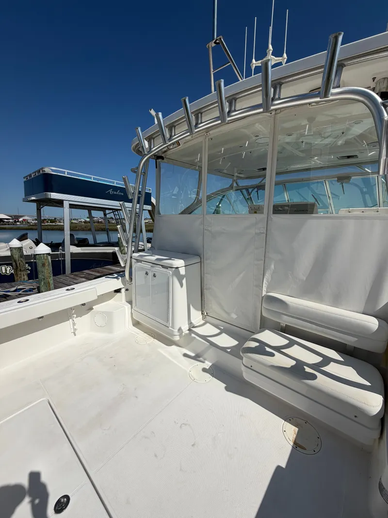 Slide: The Image of 2005 Rampage 33 Express boat with spacious deck and seating area. - 7