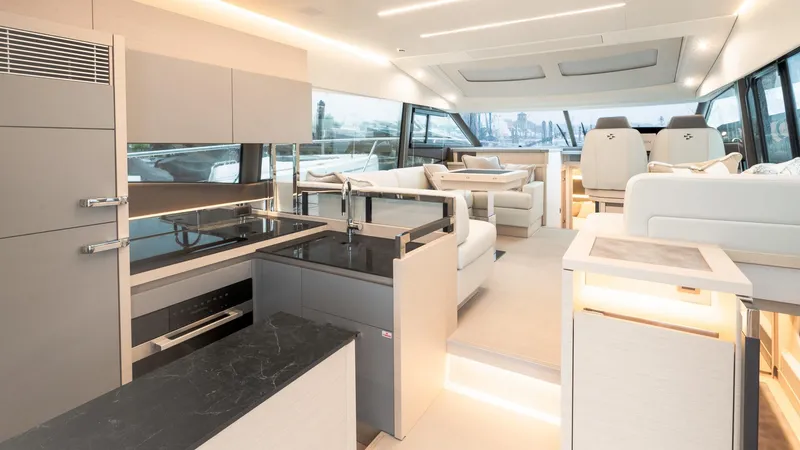Slide: The Image of Luxurious interior of 2023 Prestige 520S yacht with modern kitchen and seating area. - 10