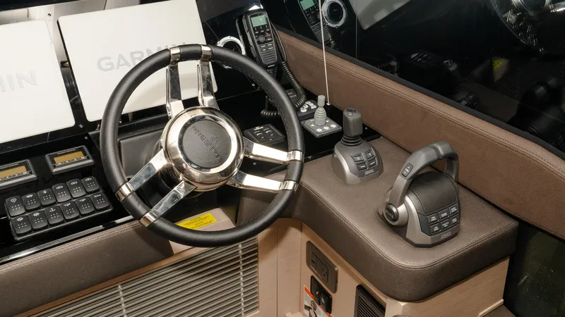 Slide: The Image of Control panel of 2023 Prestige 520S yacht with steering wheel and navigation equipment. - 14