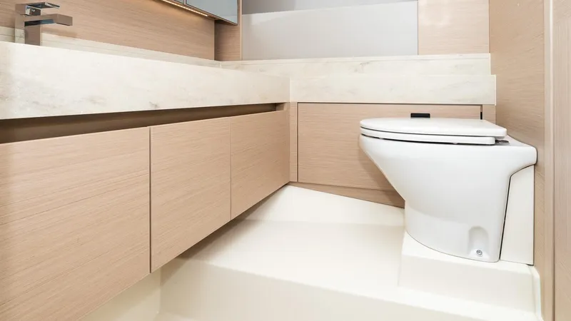 Slide: The Image of Modern bathroom interior in 2023 Prestige 520S yacht, featuring sleek cabinetry and a compact toilet. - 18