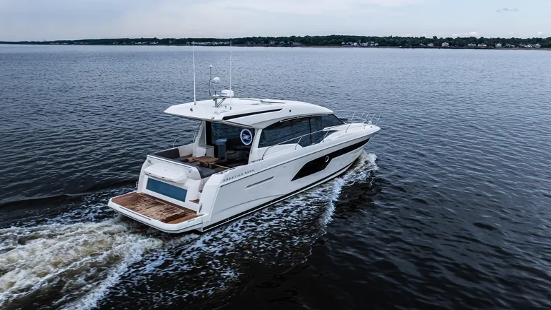 Slide: The Image of 2023 Prestige 520S yacht cruising on open water, showcasing sleek design and luxury features. - 2