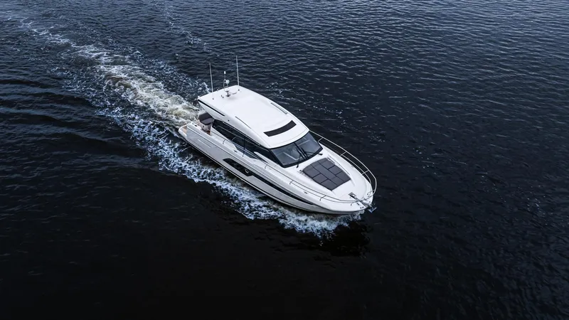 Slide: The Image of 2023 Prestige 520S yacht cruising on open water, aerial view. - 4
