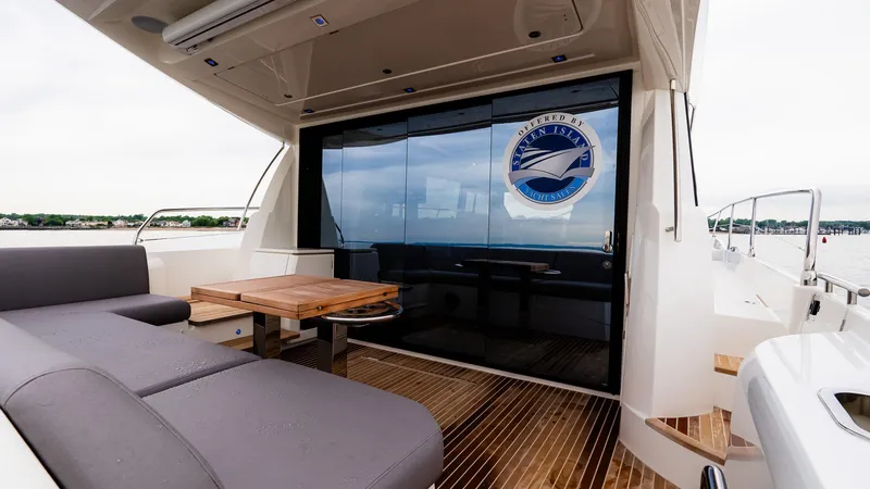 Slide: The Image of Luxurious 2023 Prestige 520S yacht with sleek deck seating and elegant wooden table. - 7