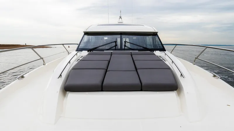 Slide: The Image of 2023 Prestige 520S yacht with sleek design and spacious sunbathing area. - 9
