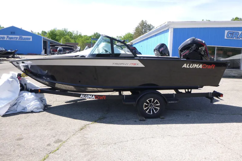The Image of 2025 Alumacraft Trophy 175X Sport boat on trailer at marina. - 1