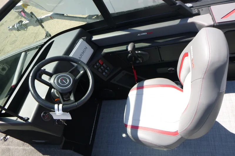 Slide: The Image of 2025 Alumacraft Trophy 175X Sport boat interior with steering wheel and captain's seat. - 11