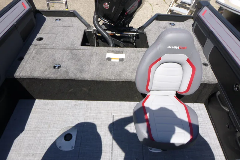 Slide: The Image of 2025 Alumacraft Trophy 175X Sport boat interior with gray and red seating. - 14