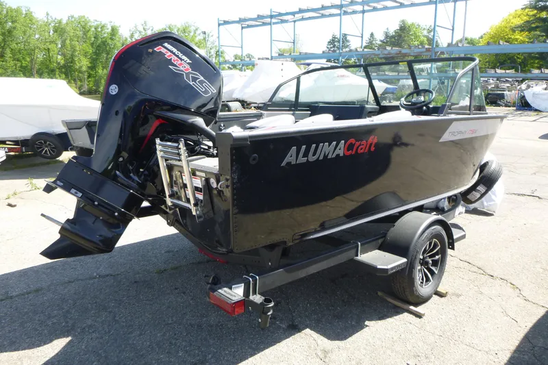 Slide: The Image of 2025 Alumacraft Trophy 175X Sport boat with Mercury engine on trailer. - 4