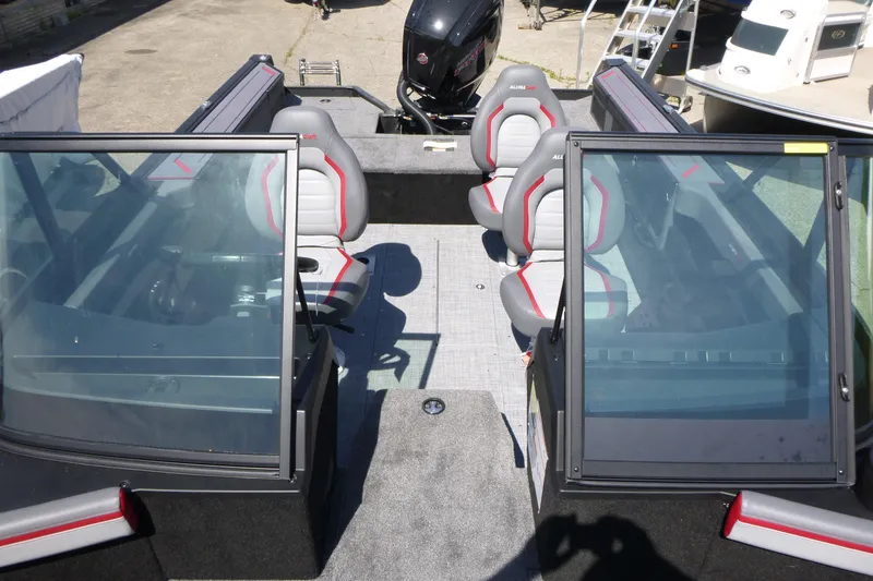 Slide: The Image of 2025 Alumacraft Trophy 175X Sport boat interior with seating and windshield. - 6