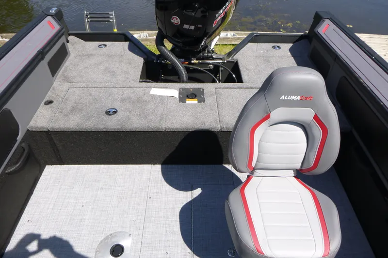 Slide: The Image of 2025 Alumacraft Trophy 185X Sport boat interior with seating and motor view. - 14