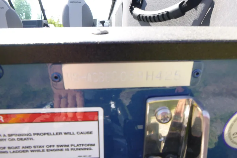 Slide: The Image of 2025 Alumacraft Trophy 185X Sport boat with visible identification plate and warning label. - 19