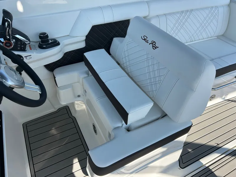 Slide: The Image of Interior of the Sea Ray SDX 290 Outboard with sleek white seating and modern controls. - 18