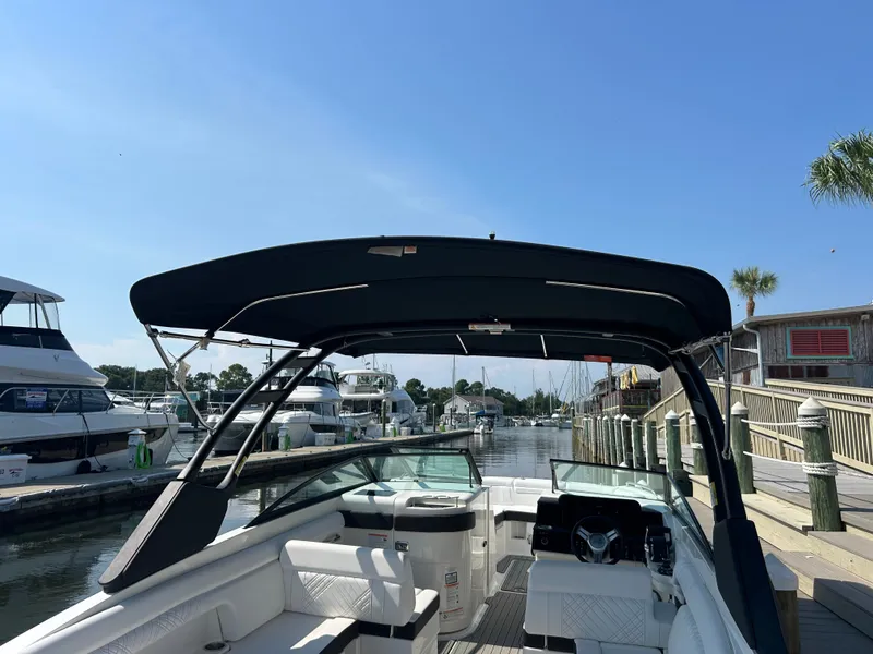 Slide: The Image of The image shows a 2027 Sea Ray SDX 290 Outboard boat in a marina. - 12