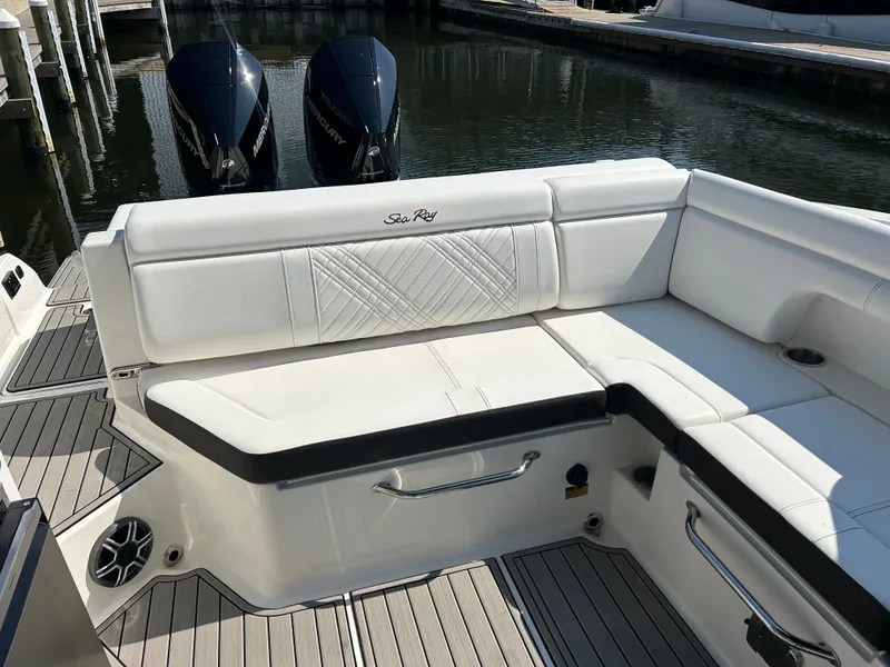 Slide: The Image of The 2027 Sea Ray SDX 290 Outboard features a sleek white bench seat and two outboard engines. - 15