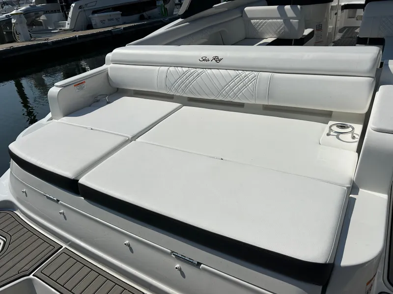 Slide: The Image of The 2027 Sea Ray SDX 290 Outboard features a spacious white sun deck with sleek upholstery. - 11