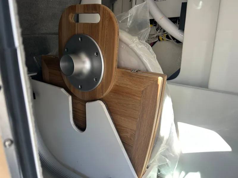 Slide: The Image of A wooden table leaf with a metal mount in a boat storage compartment. - 22