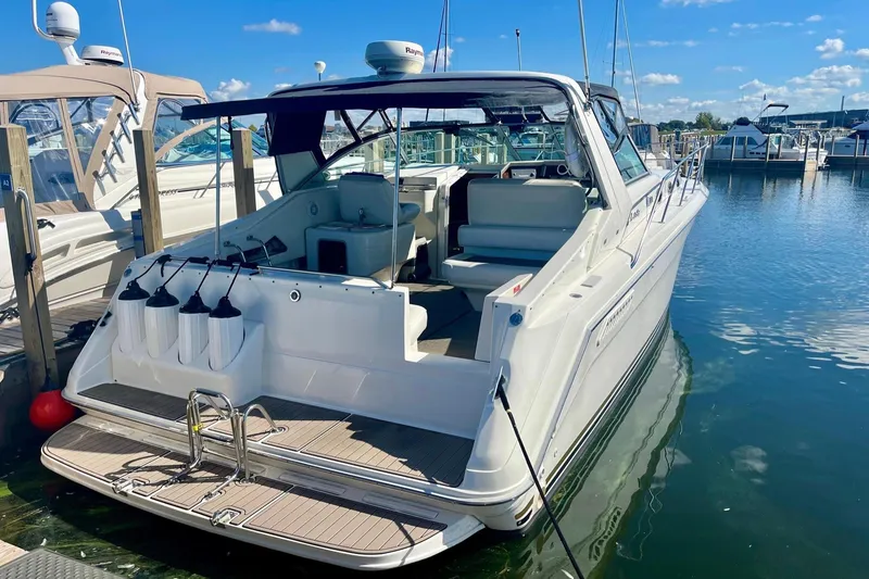Slide: The Image of 1994 Sea Ray 370 Express Cruiser docked at marina under clear blue sky. - 11
