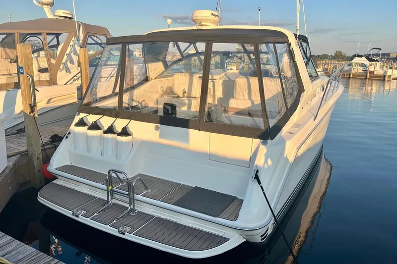 Slide: The Image of 1994 Sea Ray 370 Express Cruiser docked at marina, rear view. - 12