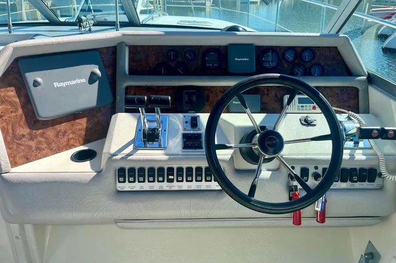 Slide: The Image of 1994 Sea Ray 370 Express Cruiser helm with Raymarine electronics and classic steering wheel. - 14