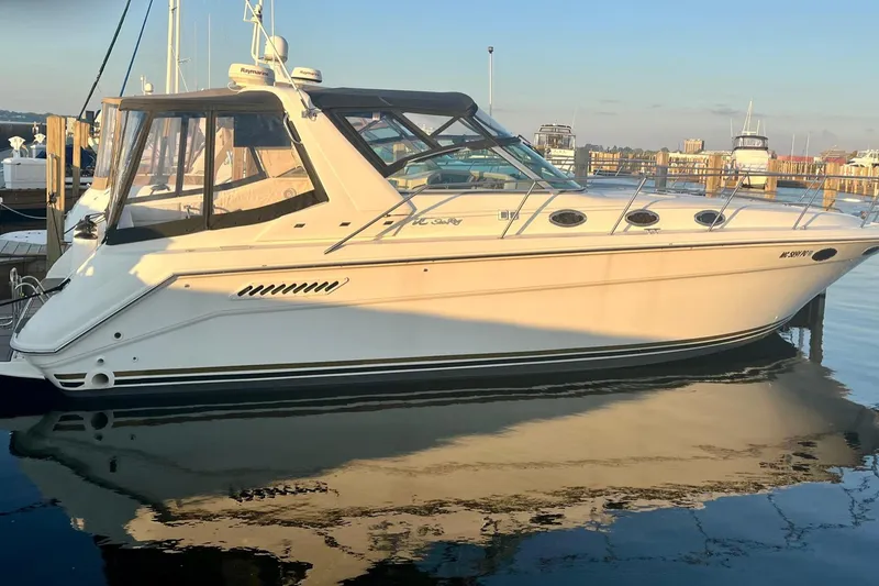 Slide: The Image of 1994 Sea Ray 370 Express Cruiser docked at marina, reflecting on calm water. - 2