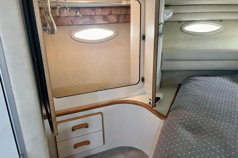 Slide: The Image of Interior of 1994 Sea Ray 370 Express Cruiser with closet and bed. - 26