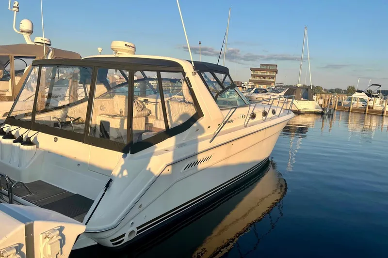 Slide: The Image of 1994 Sea Ray 370 Express Cruiser docked at marina during sunset. - 3