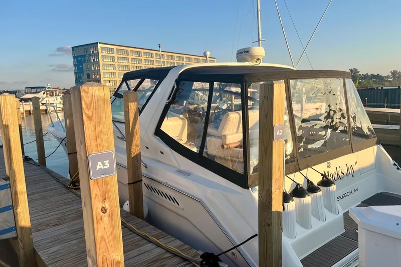 Slide: The Image of 1994 Sea Ray 370 Express Cruiser docked at marina, sunny day, clear enclosure. - 4