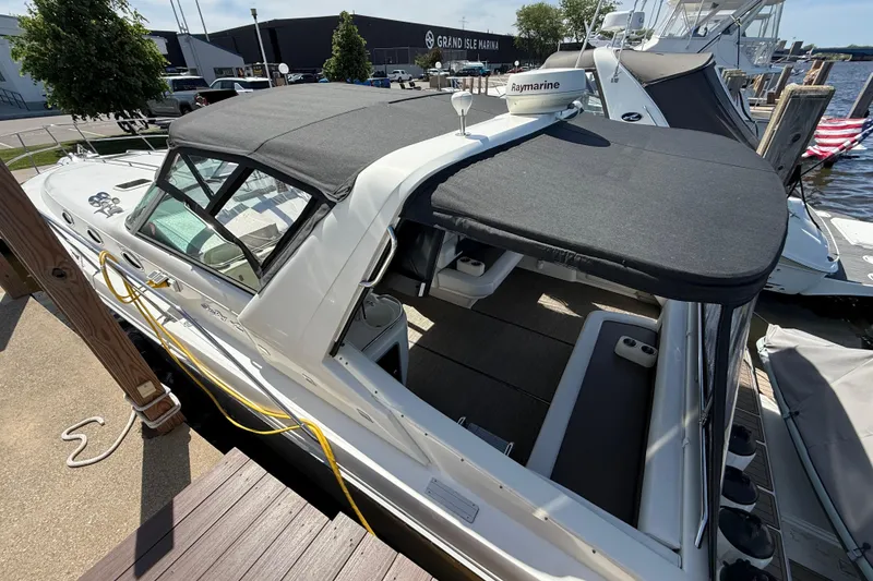 Slide: The Image of 1994 Sea Ray 370 Express Cruiser docked at marina with black canopy. - 5