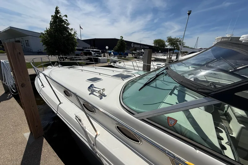 Slide: The Image of 1994 Sea Ray 370 Express Cruiser docked at marina under clear blue sky. - 6