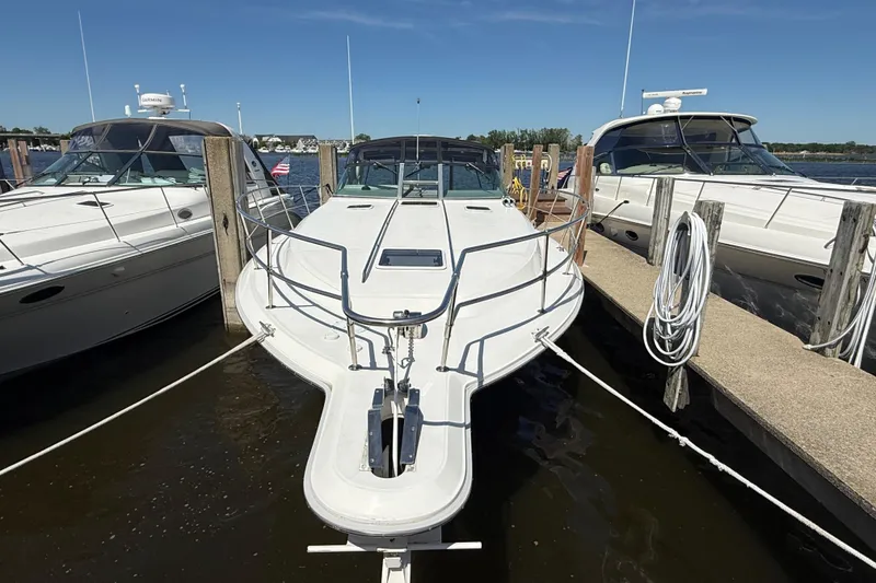 Slide: The Image of 1994 Sea Ray 370 Express Cruiser docked between two boats. - 7
