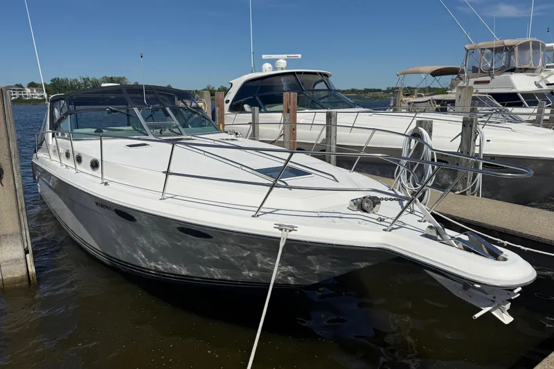 Slide: The Image of 1994 Sea Ray 370 Express Cruiser docked at marina under clear blue sky. - 8