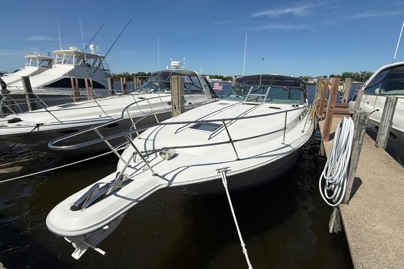Slide: The Image of 1994 Sea Ray 370 Express Cruiser docked at marina under clear blue sky. - 9