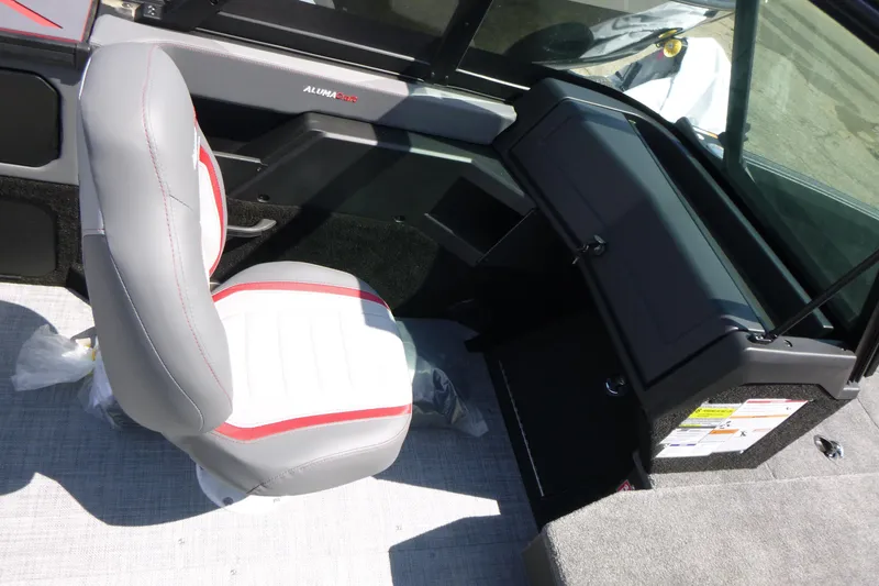 Slide: The Image of 2025 Alumacraft Trophy 185X Sport boat interior with gray and red seating. - 13