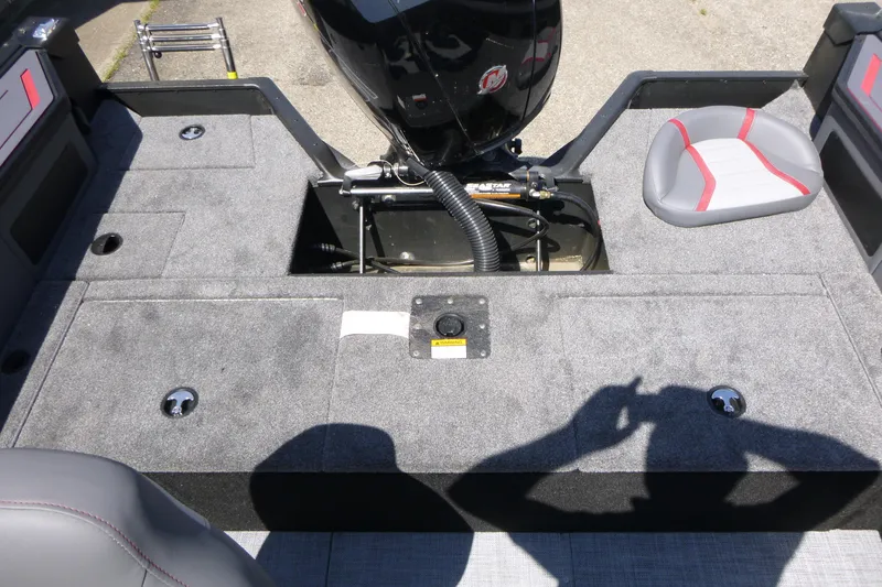 Slide: The Image of 2025 Alumacraft Trophy 185X Sport boat interior with motor and seating. - 14