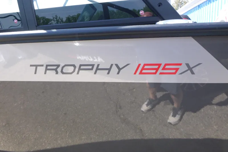 Slide: The Image of 2025 Alumacraft Trophy 185X Sport boat logo on side panel. - 17