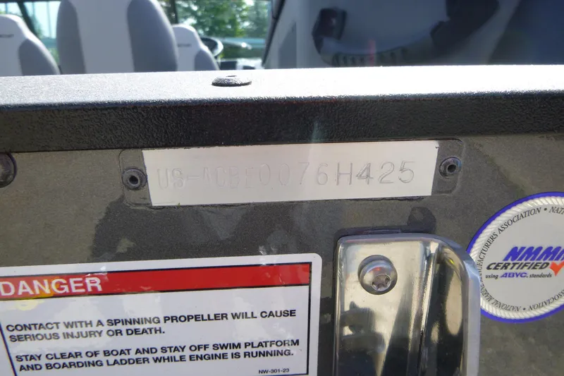 Slide: The Image of 2025 Alumacraft Trophy 185X Sport boat identification plate with safety warning labels. - 18