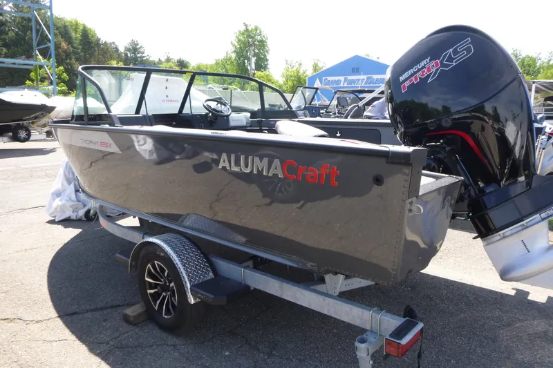 Slide: The Image of 2025 Alumacraft Trophy 185X Sport boat with Mercury Pro XS engine on trailer. - 2