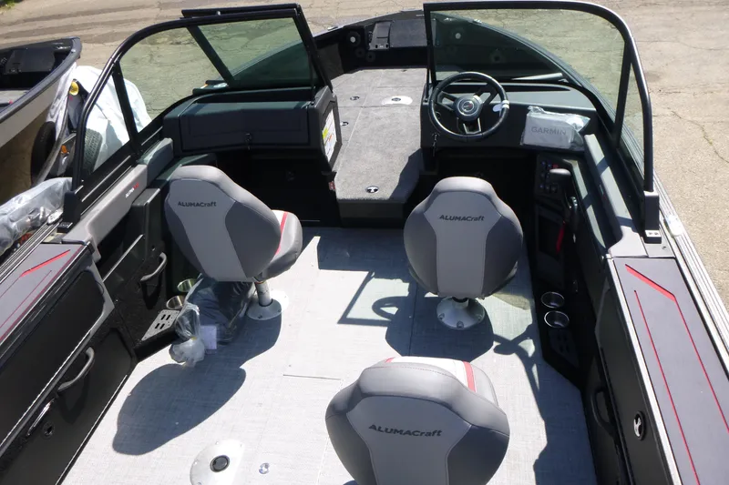Slide: The Image of 2025 Alumacraft Trophy 185X Sport boat interior with seating and steering console. - 5