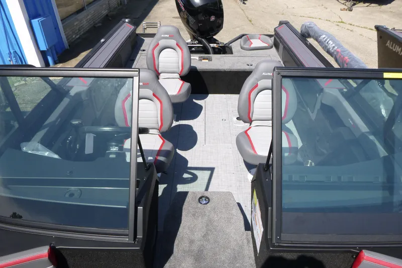 Slide: The Image of 2025 Alumacraft Trophy 185X Sport boat interior with seating and windshield. - 6