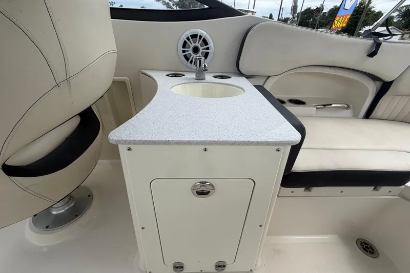Slide: The Image of 2023 Stingray 231 DC boat interior with sink and seating area. - 17