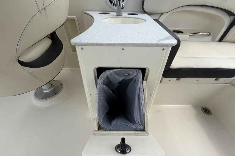 Slide: The Image of Interior of 2023 Stingray 231 DC boat with sink and trash compartment. - 18